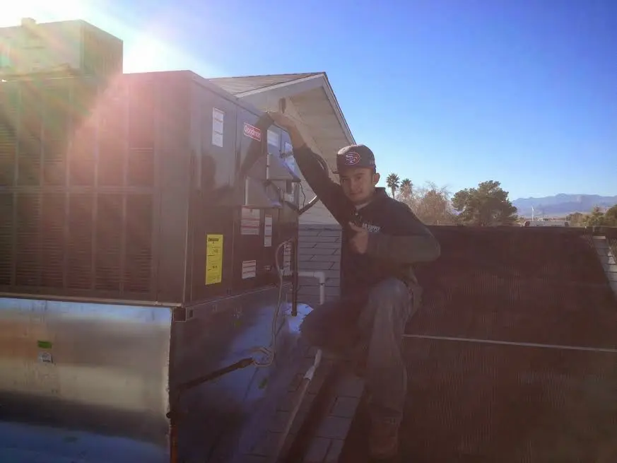 HVAC technician performing AC Tune-Up on a rooftop unit in Selinsgrove